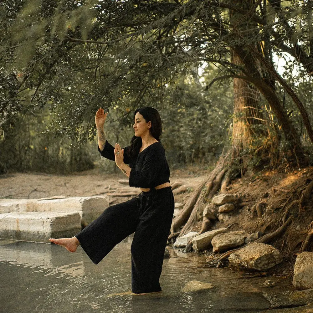 Angela practicing qigong in nature