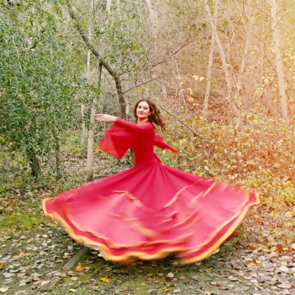 Farima dancing in a red dress, in nature