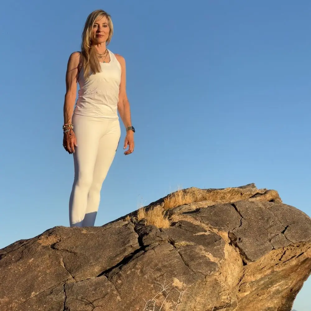 Jennifer Prugh standing on top a rock ledge