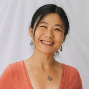 photo of julie lin smiling with an orange shirt