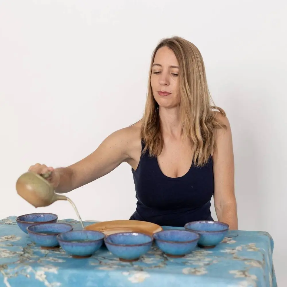 Katie pouring tea into blue tea cups