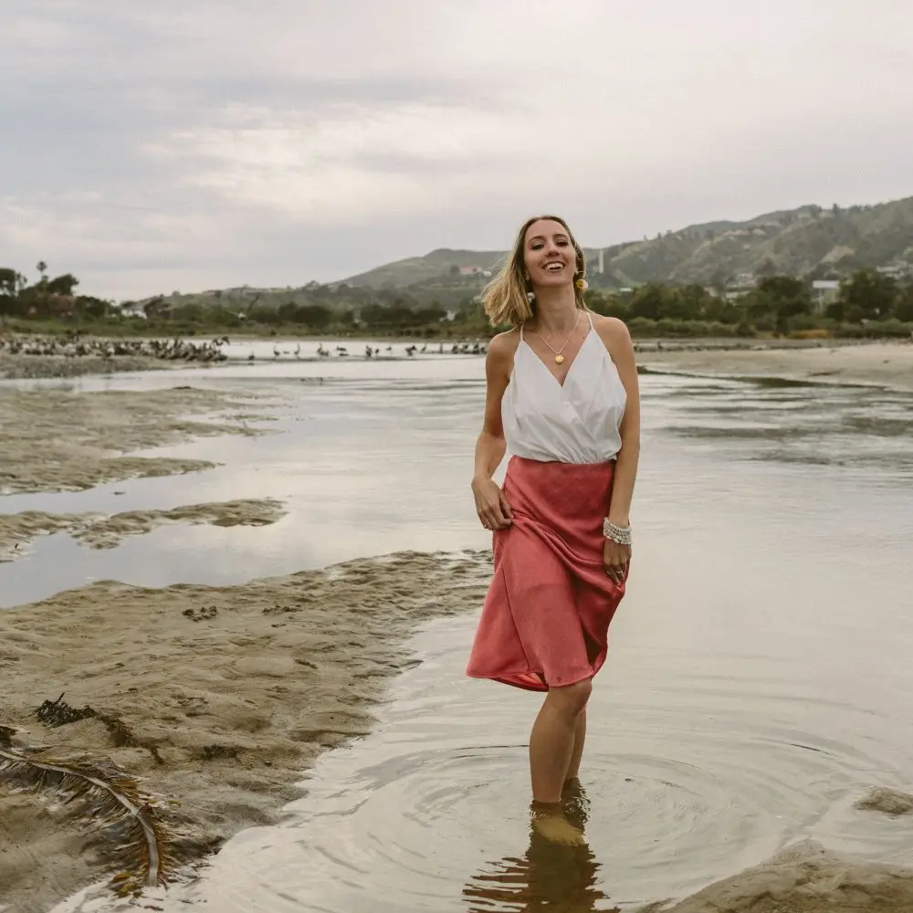 Katie walking along a beach