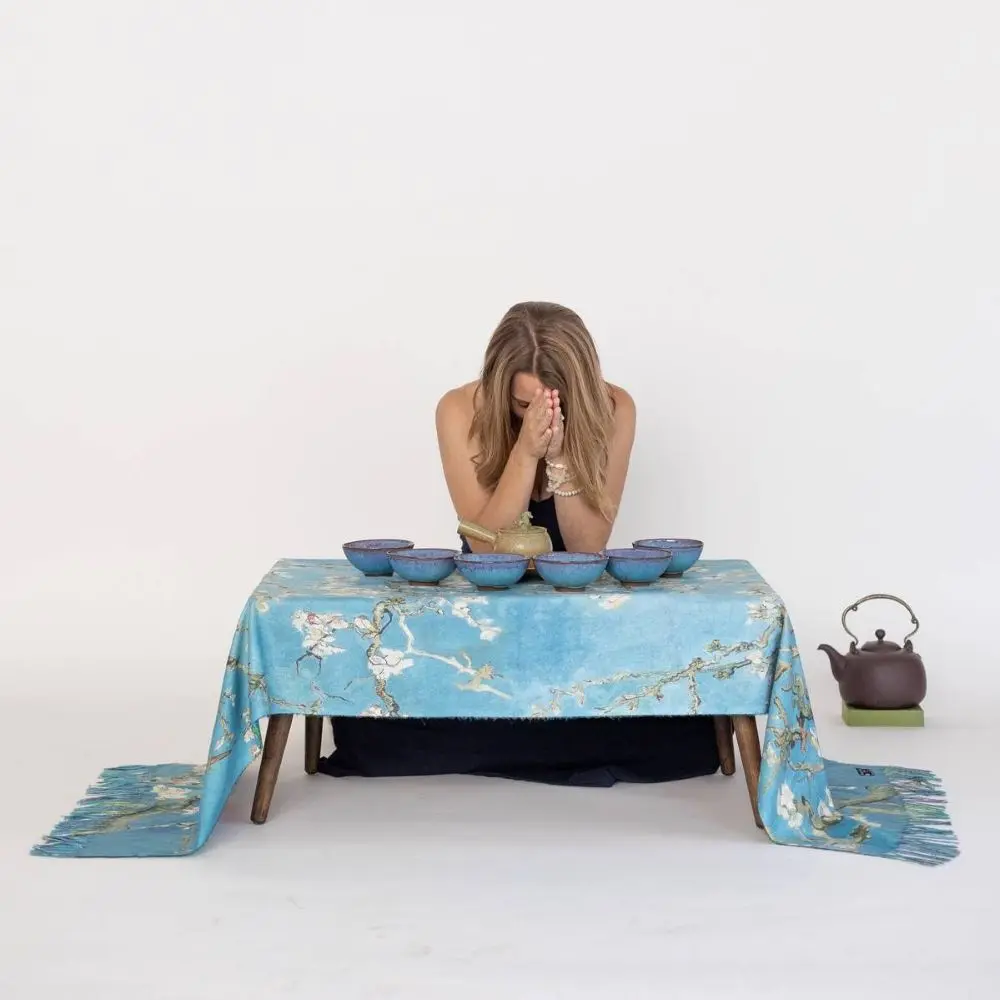 Katie in prayer with tea