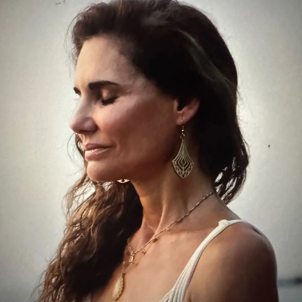 Profile view of Maria Ortega with her eyes closed.