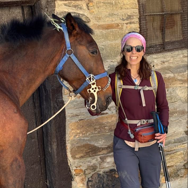 Jill Lacher petting a horse