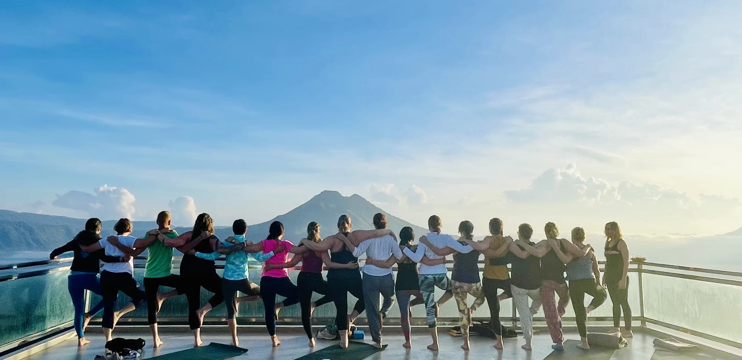 bali retreat group standing together looking out at a view of a distant volcano