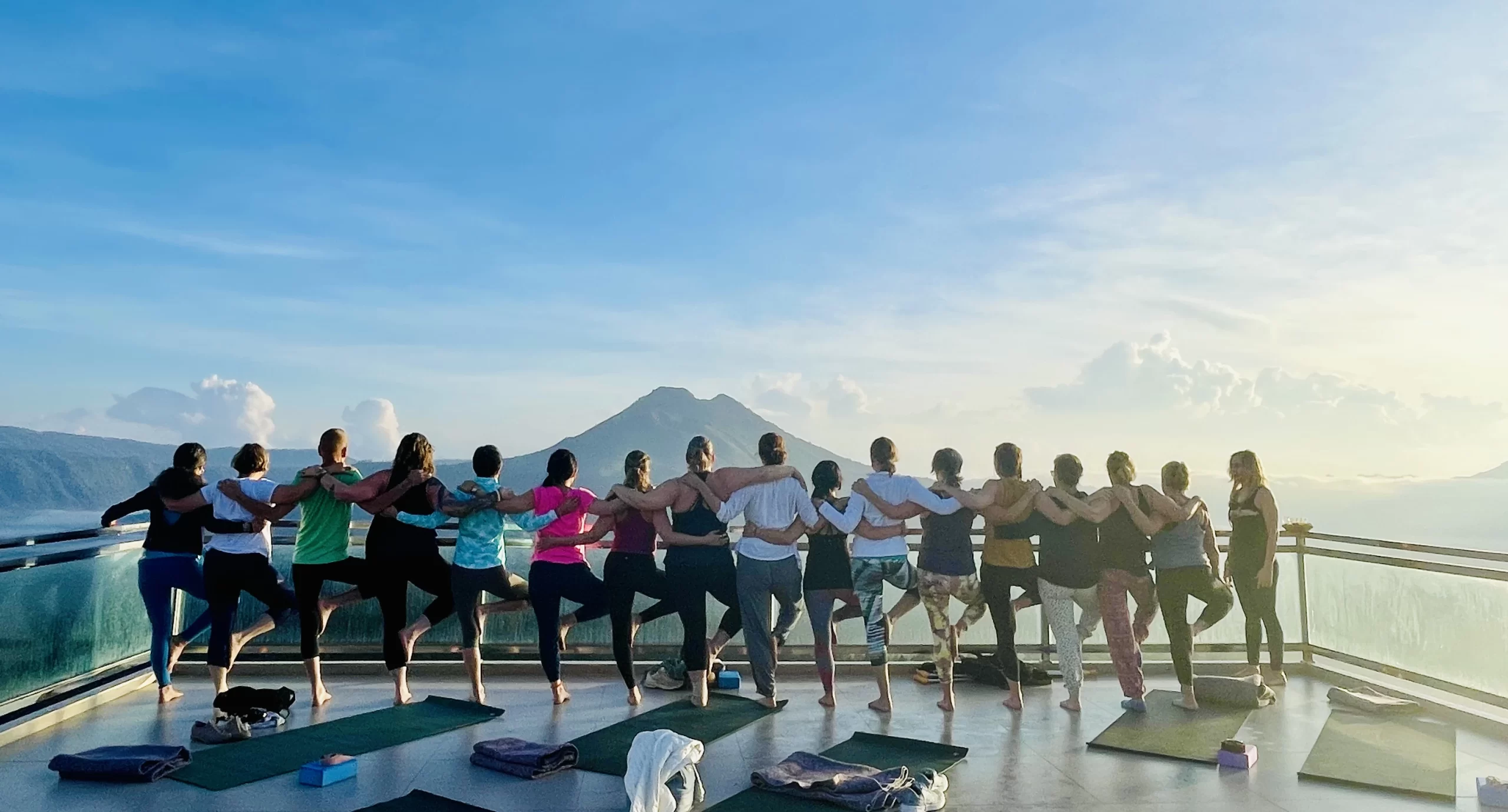 bali retreat group standing together looking out at a view of a distant volcano