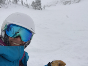 Bridget in snowboarding gear on a mountain