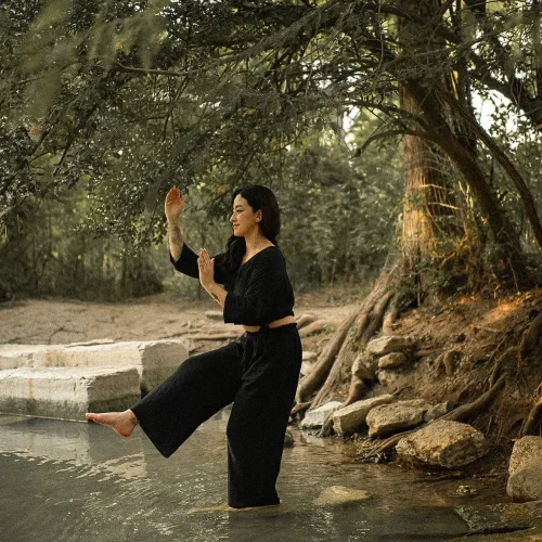 Angela practicing qigong in nature