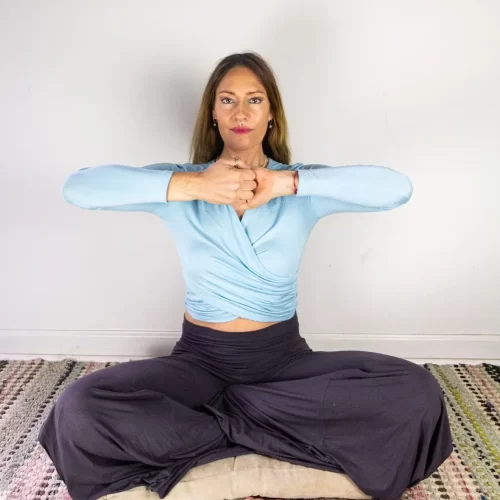 Naomi Wilder seated, practicing a bear grip.