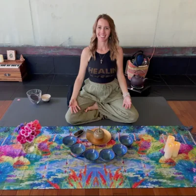 Katie Davidson seated in a yoga studio next to a tea display