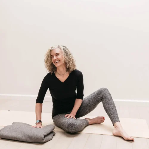 Leslie Howard seated and smiling
