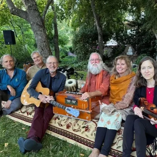 6 band members of Mangalananda and friends seated outdoors