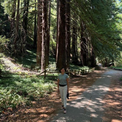 Marcela walking in a forest.