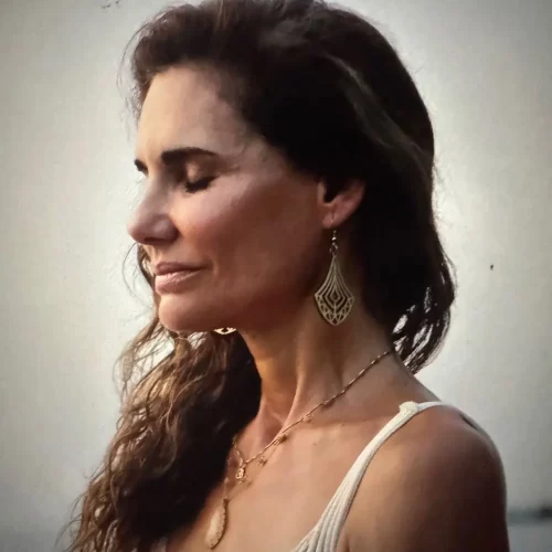 Profile view of Maria Ortega with her eyes closed.