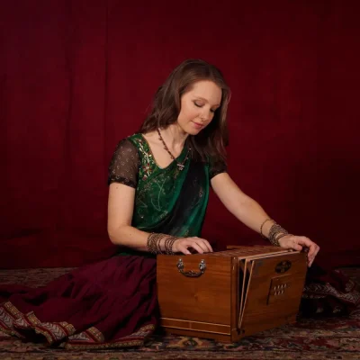 Prajna playing a harmonium