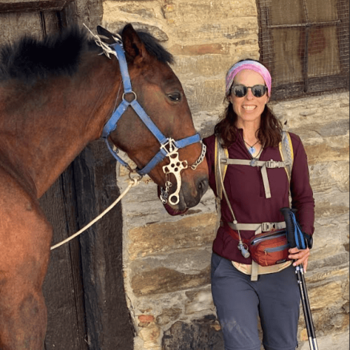 Jill Lacher petting a horse