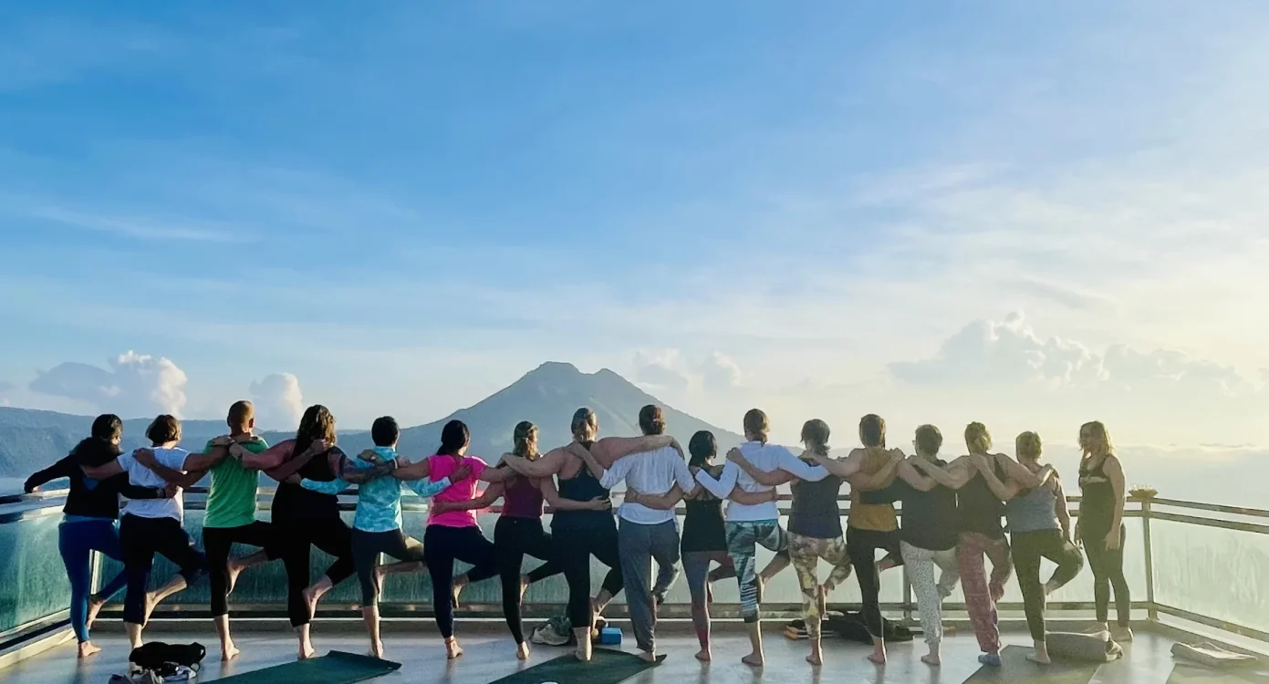 bali retreat group standing together looking out at a view of a distant volcano