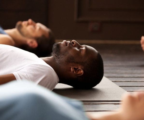 Man rests in savasana