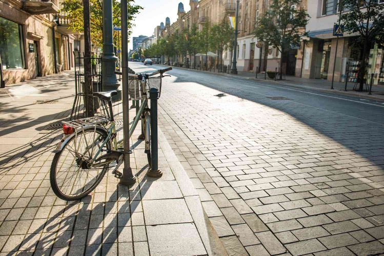 Bike on city street with empty road and morning light in Europe, Lithuania, Vilnius