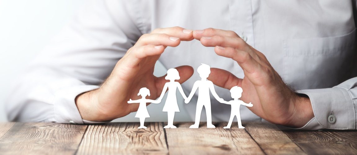 Protecting Hands Over Paper Family / Family Protection And Care Concept