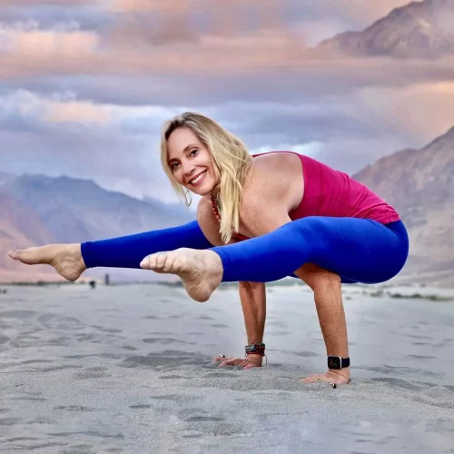 Jennifer Prugh practicing yoga on a beach.