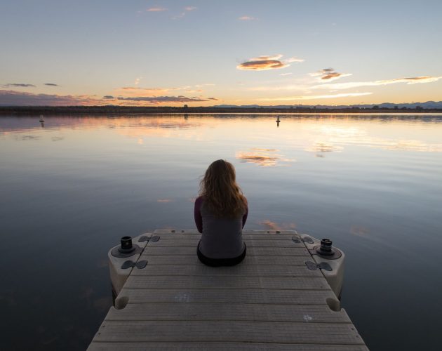 Girl sitting on Dock Sunset