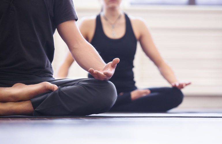 Young couple meditating together