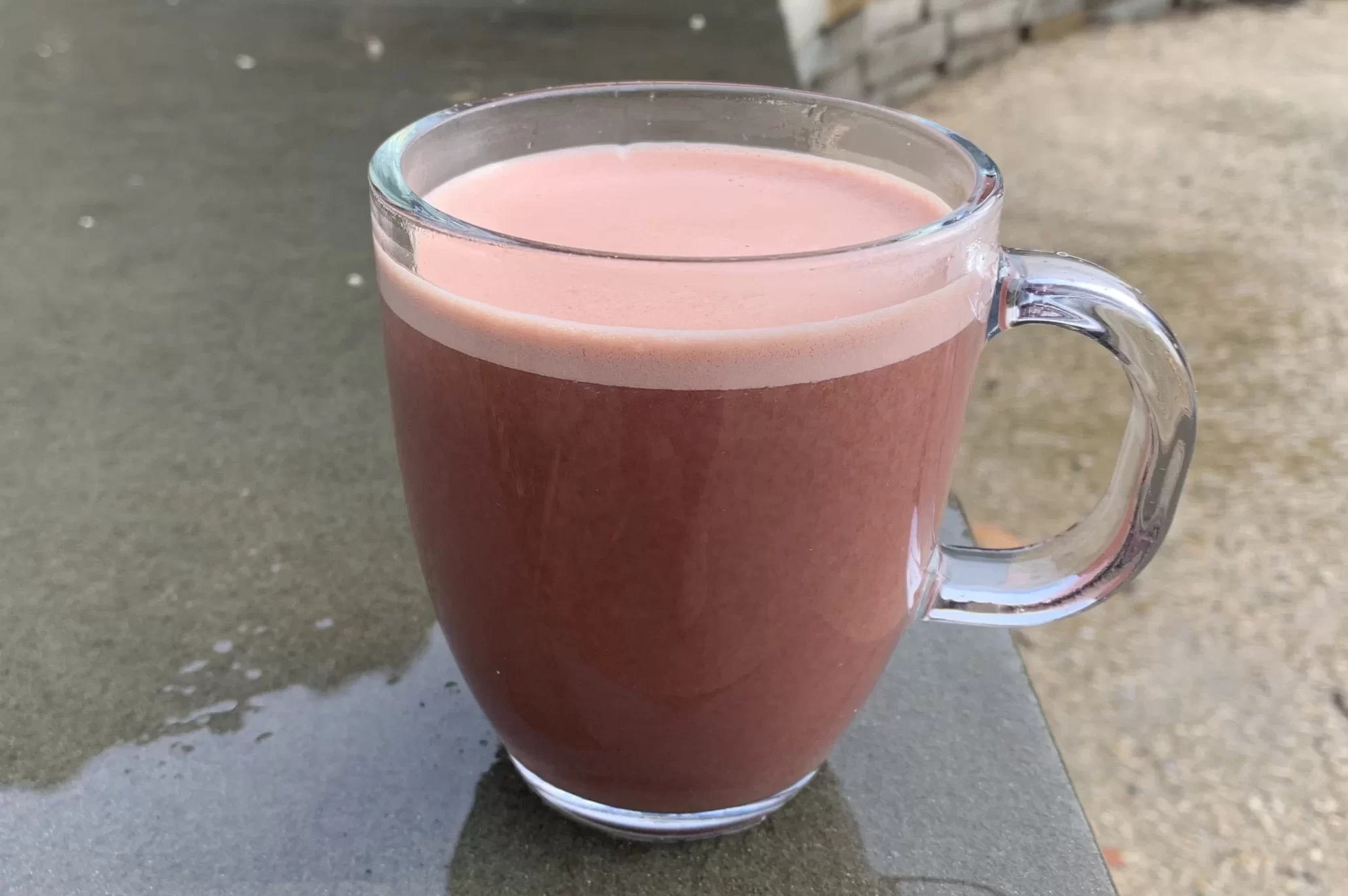 heartbeet hot chocolate in a glass mug on a rainy day