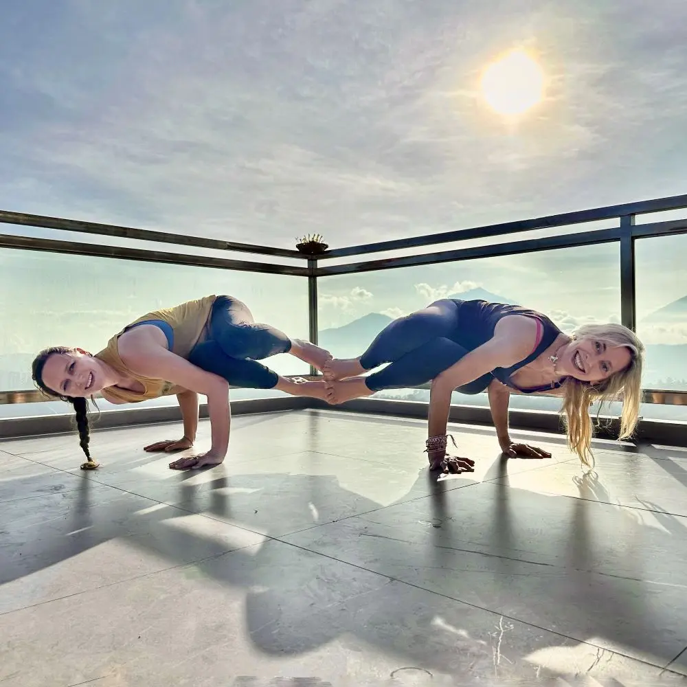 Leslie and Jennifer mirroring each other during an arm balance