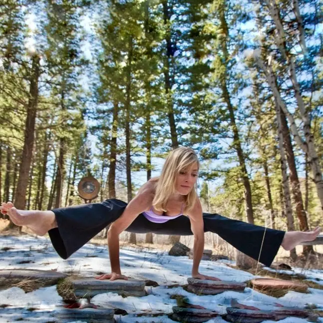 Jennifer Prugh in an asana on a snowy mountain side.