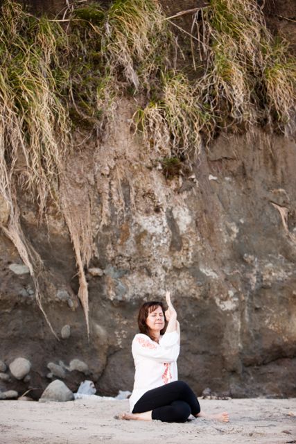 Joanne practicing yoga on a beach