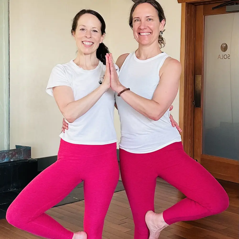jill lacher and student doing partner yoga