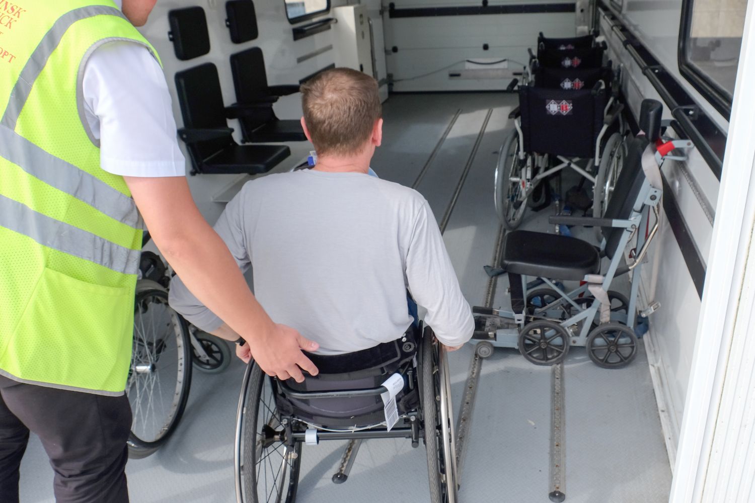man in wheelchair boarding plane